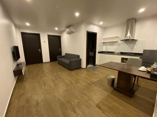 a large living room with a table and a couch at The Nova Hotel & Apartment in Hai Phong