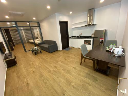 a living room with a dining table and a kitchen at The Nova Hotel & Apartment in Hai Phong
