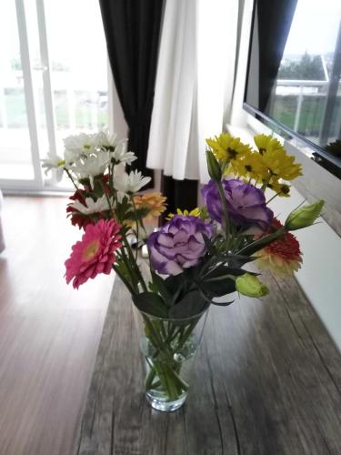 a vase filled with colorful flowers on a table at Sarp Hotel Kadriye in Belek