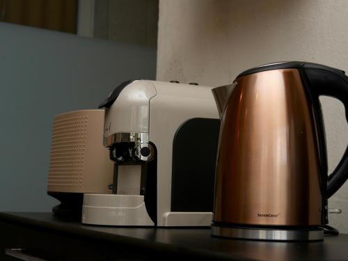 a coffee pot sitting on a counter next to a toaster at Appartement spa privatif Grenoble At Home Spa in Grenoble