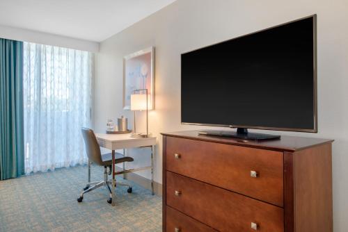 a hotel room with a flat screen television on a dresser at Holiday Inn Orlando – Disney Springs® Area by IHG in Orlando