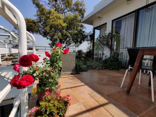 a porch with red flowers on a house at Garden Homes 1& 6 in Kolhapur