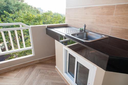 a kitchen with a sink next to a window at Diana Garden Resort - SHA Extra Plus in Pattaya Central