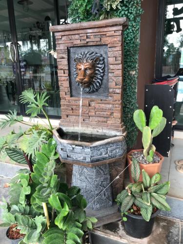 a brick fountain with a lion head on it at Ingkho Khao Kho อิงค้อ เขาค้อ in Khao Kho