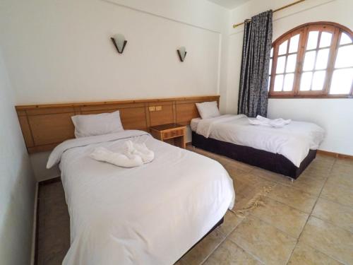 Postel nebo postele na pokoji v ubytování Jimmy Hotel