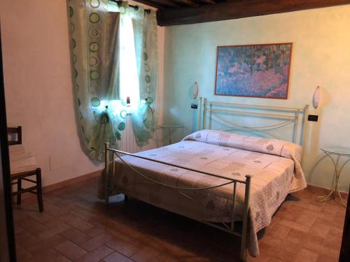 a bedroom with a bed and a window at Agriturismo Casale Giulia in Volterra