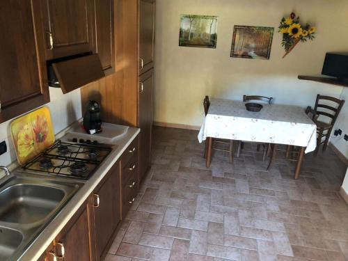 a kitchen with a table and a stove top oven at Agriturismo Casale Giulia in Volterra