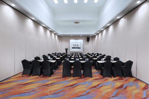 a large room with tables and chairs in it at NEO+Waru-Sidoarjo by ASTON in Sidoarjo