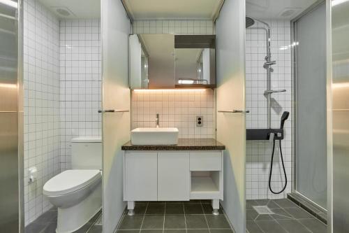 a bathroom with a toilet and a sink and a shower at Slow Stay DA in Seoul