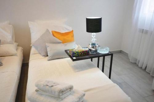a room with a couch and a table with towels on it at Tourist House Bologna - Self check-in in Bologna