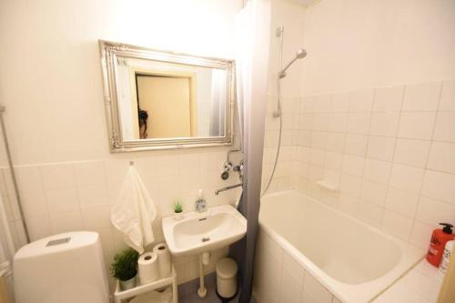 a bathroom with a sink and a toilet and a mirror at Rental Apartment Kupittaa Suomen Vuokramajoitus Oy in Turku