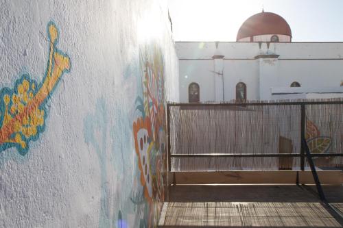 a wall with graffiti on the side of a building at Casa Calma Yoga Hostel in Agaete