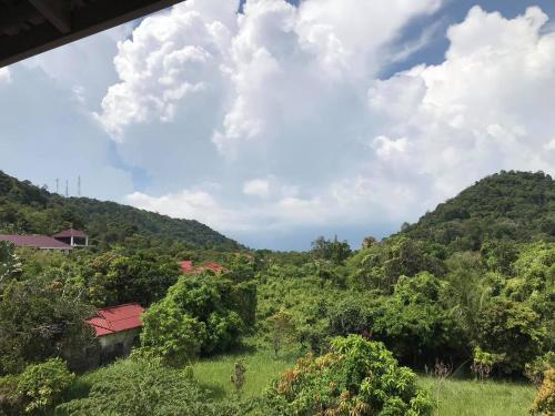 a view of a lush green hillside with a house at Kep Villa Hill Guest House 1 in Kep