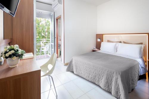 A bed or beds in a room at Hotel Foglieri