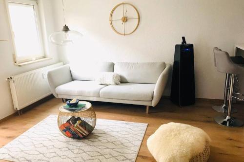 a living room with a white couch and a rug at Your beautiful Homestay in Rheinfelden