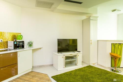 a living room with a tv and a kitchen at Seven Eleven Most City Hotel&SKYTECH in Dnipro