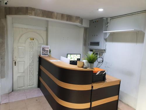 a kitchen with a counter and a white door at NK Guesthouse 2 in Bangkok
