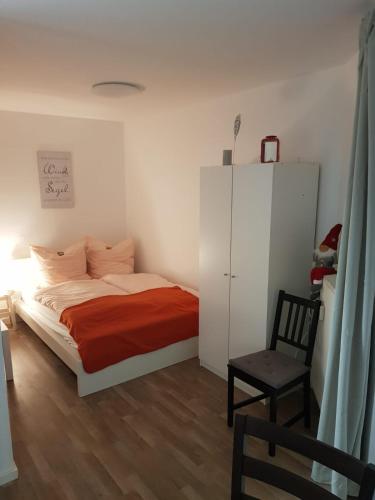 a bedroom with a bed and a chair at Harz-Glück1 in Braunlage