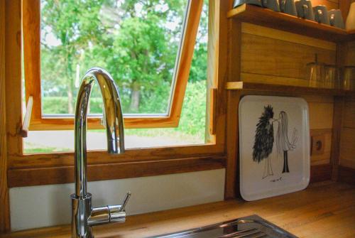 a kitchen counter with a sink and a window at Domaine de l'Oiselière in Chauché