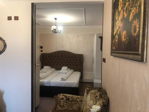 a bedroom with a bed and a chair and a mirror at Sport Residence in Bacău