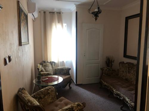 a living room with a couch and chairs and a table at Sport Residence in Bacău