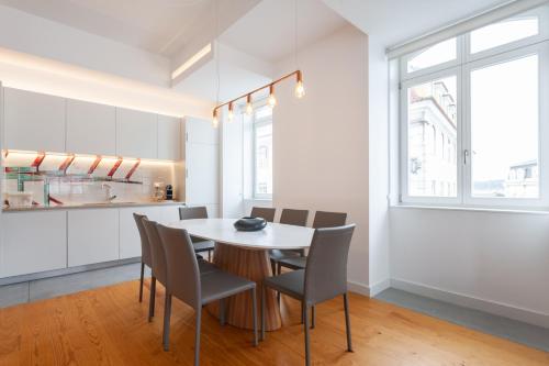 a kitchen and dining room with a table and chairs at FLH Chiado Amazing Flat in Lisbon