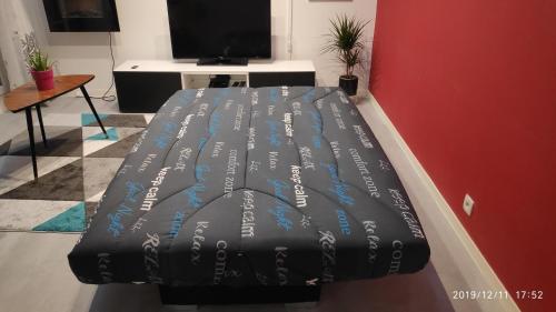 a bed with writing on it in a room at 15 min walk to DisneylandParis, 5 min walk to Val d'Europe Mall and train RER A, Monyhome apartment for 4 persons in Chessy