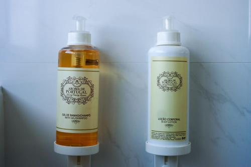 two bottles of soap sitting next to each other at Cascais City & Beach Hotel in Cascais