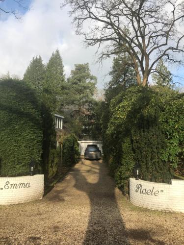 a car driving down a driveway with a house at Modern Palace Emma Staete in Baarn