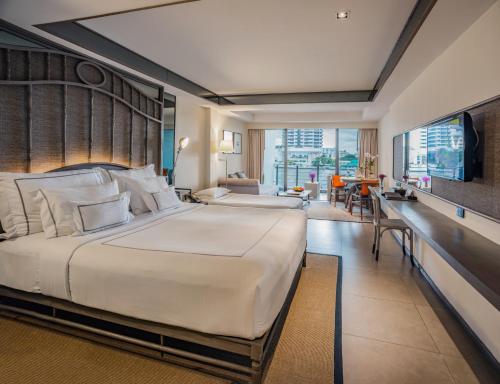 A bed or beds in a room at Riva Surya Bangkok - SHA Extra Plus