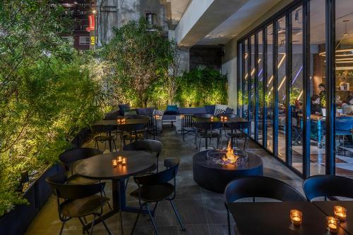 a restaurant with tables and chairs and a fire pit at slash kawasaki in Kawasaki