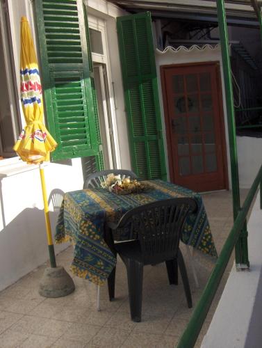 a table and a umbrella and a table and chairs at Appartamento Torrione in Piani di Vallecrosia
