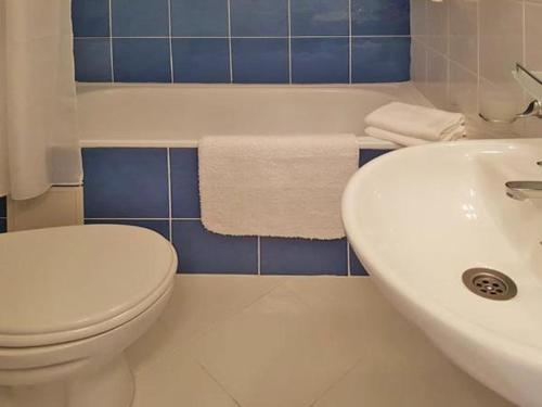 a bathroom with a white toilet and a sink at SP Luxury Loft 28 in Ravda