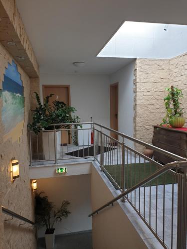 a staircase in a building with potted plants at Zimmer for you in Rösrath