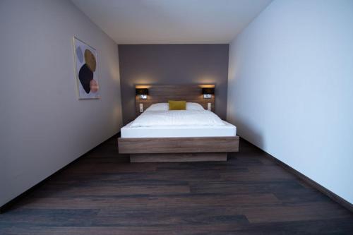a bedroom with a white bed in a room at V Boutique Hotel Böblingen in Böblingen