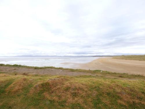an empty beach with the ocean in the background at No 17 Mountain Dale in Tullaghan