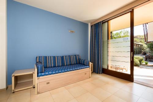 a room with a bench and a door to a patio at Canado Club Family Village in Marina di Castagneto Carducci
