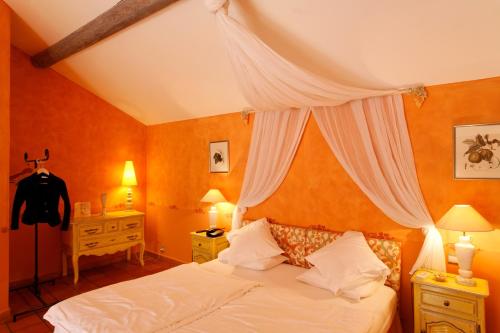a bedroom with a bed with a canopy at Château d'Adomenil in Rehainviller