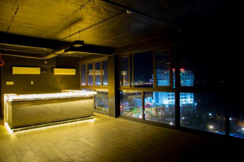 a room with a view of a city at night at Money Fine Quy Nhơn - Khách sạn dát vàng in Quy Nhon