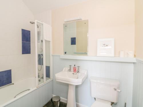 a white bathroom with a sink and a toilet at The Lodge at Raheengraney House in Cluain na nGall