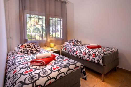 En eller flere senge i et værelse på Villa das Palmeiras