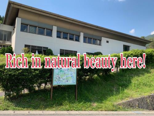 a sign that says rich to natural beauty here in front of a building at Hotel Miki in Gero