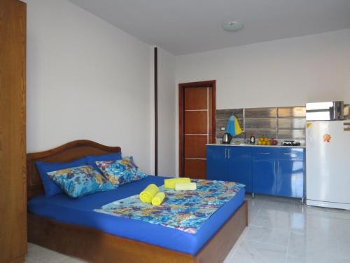 Apartment Stella di Mari near the sea RedSeaLine في الغردقة: غرفة نوم بسرير ازرق وثلاجة