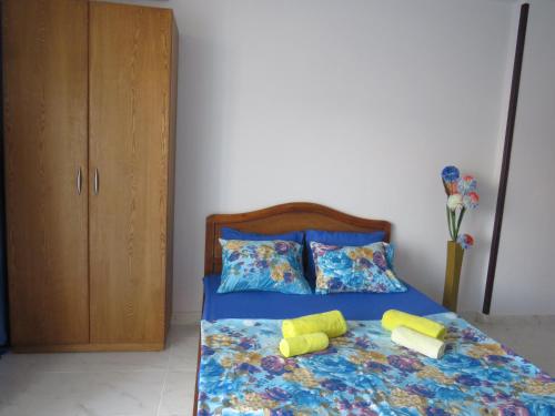 a bedroom with a bed with two pillows and a cabinet at Apartment Stella di Mari near the sea RedSeaLine in Hurghada