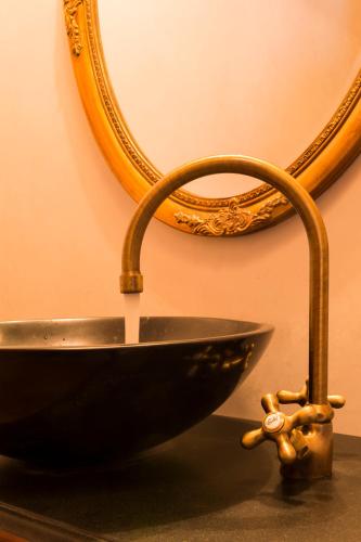 a bathroom sink with a faucet and a sink at Das Kitz - deLuxe ChaletApartments in Jochberg
