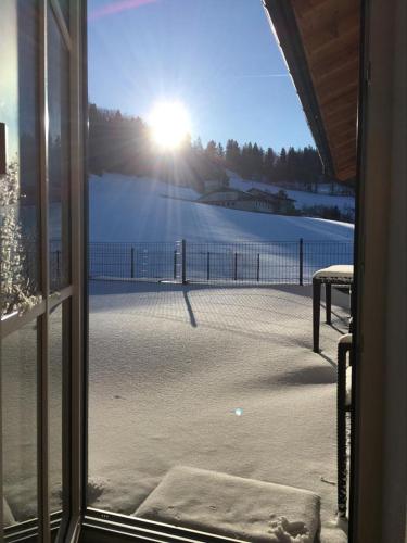 a view of a tennis court from a window at Fitzlhof in Sankt Koloman