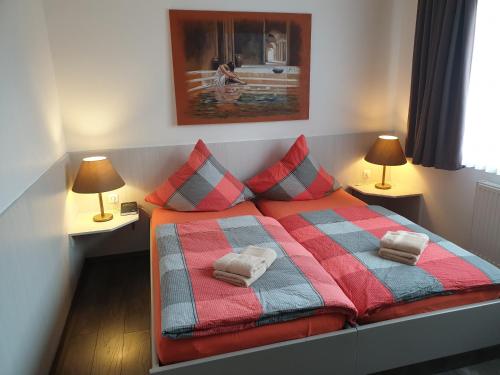 a bed with two pillows on it in a bedroom at Zimmer for you in Rösrath