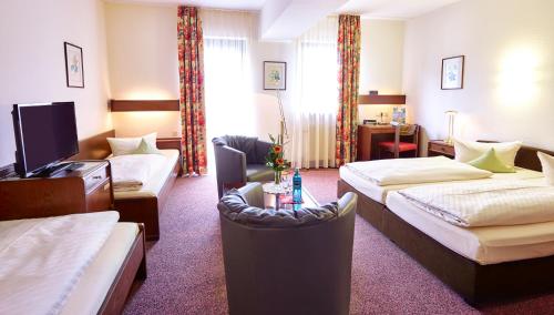 Postel nebo postele na pokoji v ubytování Hotel Merian Rothenburg