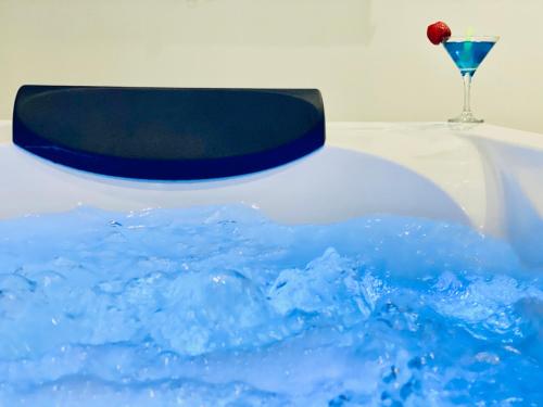 a blue cake with a black top and a glass at Canaryislandshost l Brisa del Atlántico in Playa Honda