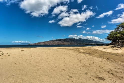 an empty beach with a mountain in the background at Stunning South Maui Condo with Lanai by Beach! in Kihei